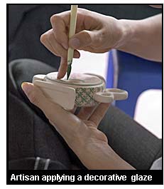 Artisan applying a decorative glaze